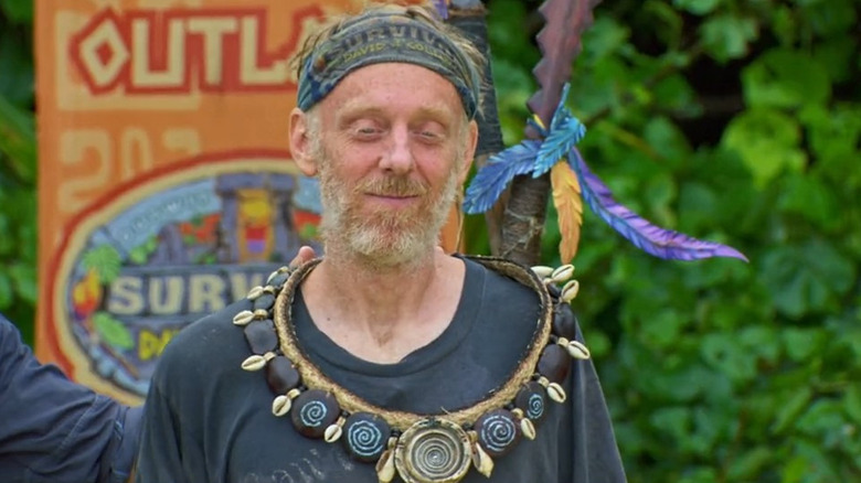 Mike White smiling and wearing the immunity necklace in "Survivor."