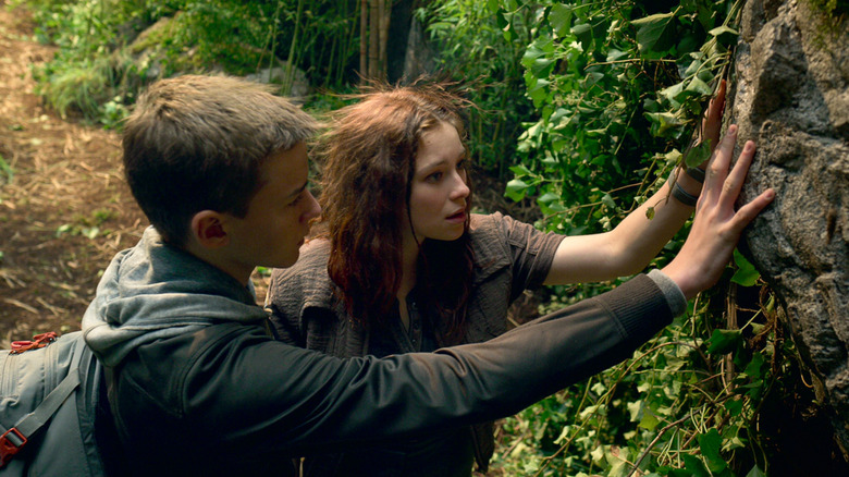Will Robinson and Penny examining rocks