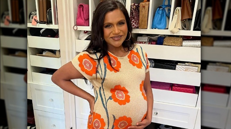 Mindy Kaling holding her baby bump (2024)