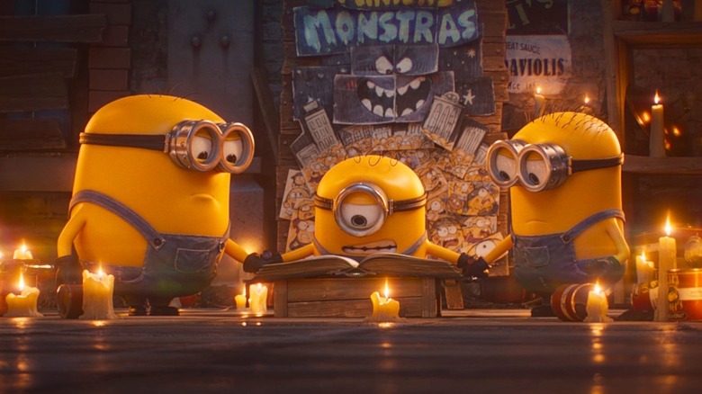 The Minions trying to cast a spell in front of their movie poster (2026)