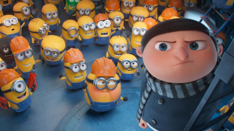 Young Gru standing above Minions