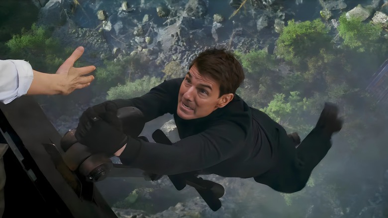 Ethan Hunt hanging over a deep chasm
