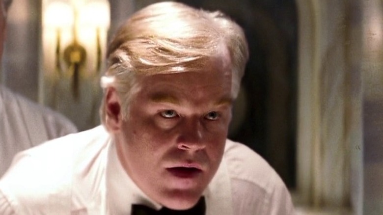 Owen Davian leans forward