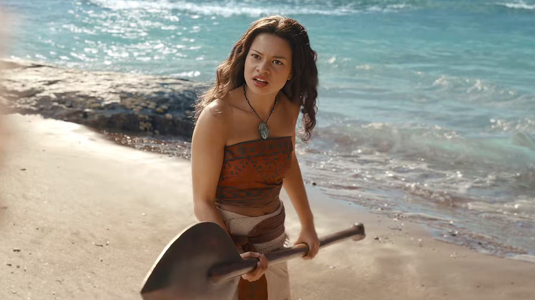 Moana holding a spear looking confused in Moana