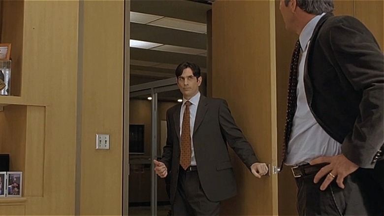Enrique holding the door open in "In Good Company"