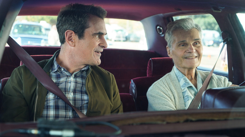 Phil smiling at Frank Dunphy in the car on "Modern Family"