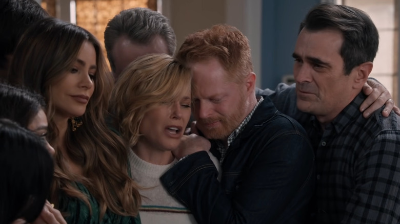 Phil, Claire, Gloria, and Mitchell hugging and crying