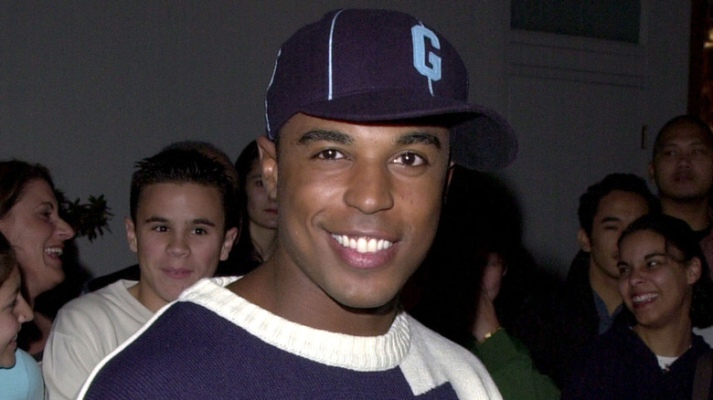 Merlin Santana smiles at a red carpet event