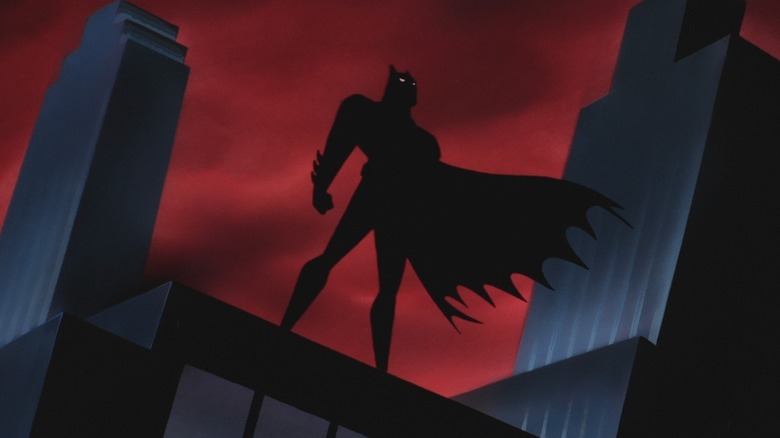 Animated Batman silhouetted on rooftop