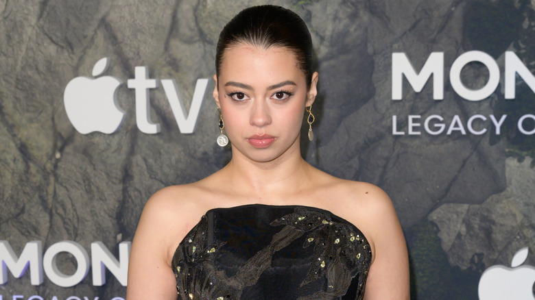 Amber Midthunder wearing a black dress