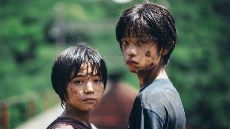 Eri and Minato standing muddy 