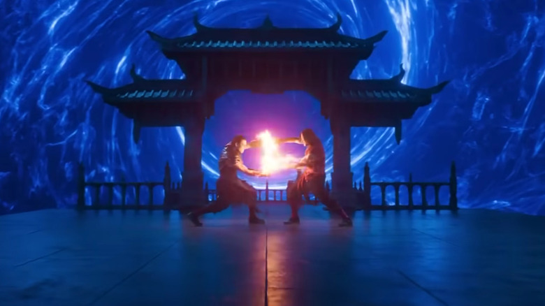 Kung Lao and Liu Kang fighting in front of a blue portal in "Mortal Kombat 2" (2026)