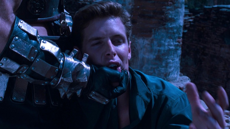 Shao Kahn holding Johnny Cage's jaw in Mortal Kombat: Annihilation
