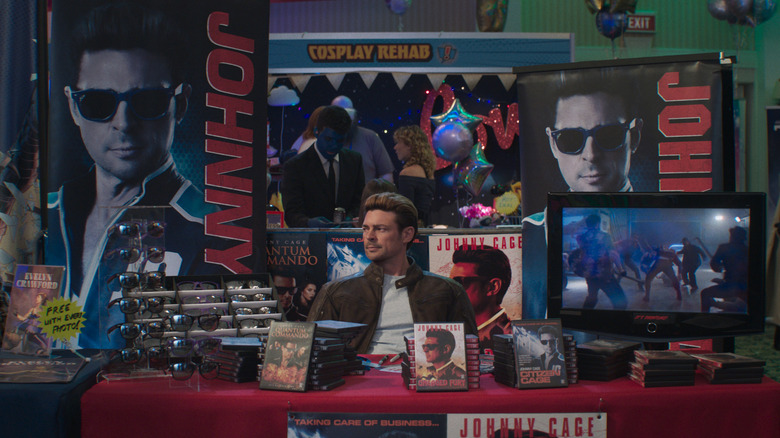Johnny Cage sitting at merch table n Mortal Kombat II (2026)