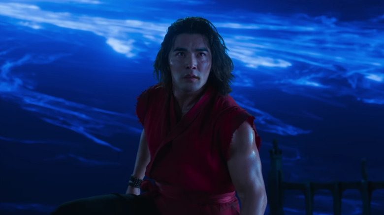 Liu Kang standing in front of a blue portal in Mortal Kombat II
