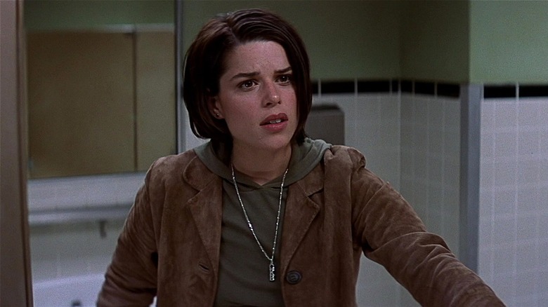 Sidney Prescott looking confused opening bathroom stall door (2000)