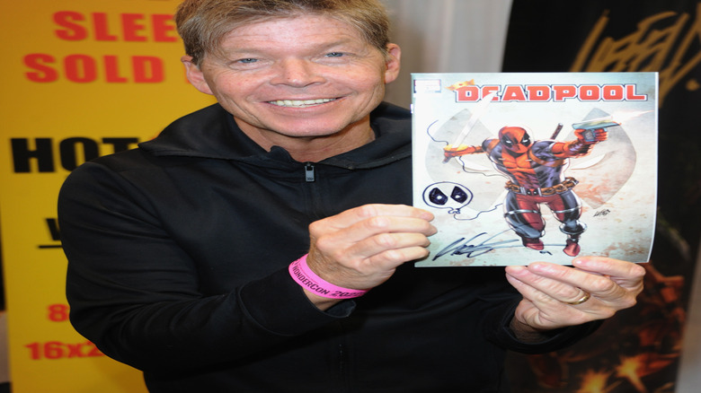 Rob Liefeld holds Deadpool comic