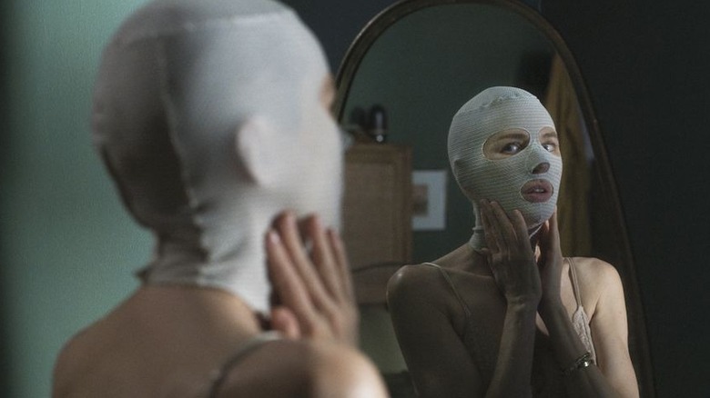 Mother staring at herself in the mirror