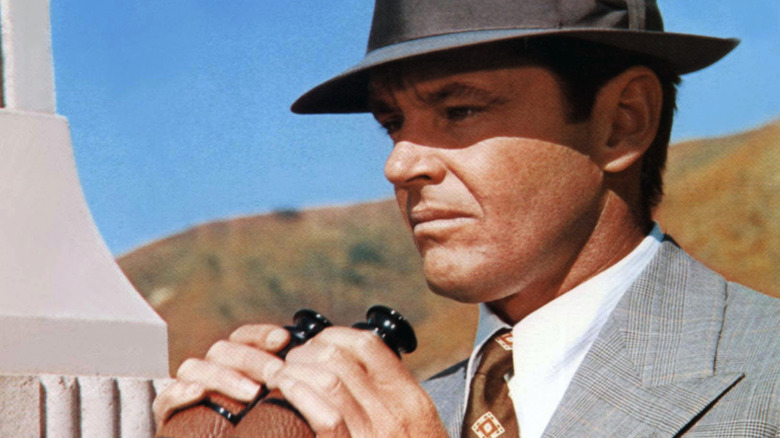 Jake Gittes looks through binoculars in "Chinatown"