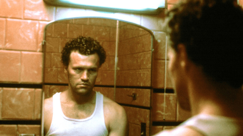 Henry glares at himself in the mirror in "Henry: Portrait of a Serial Killer"