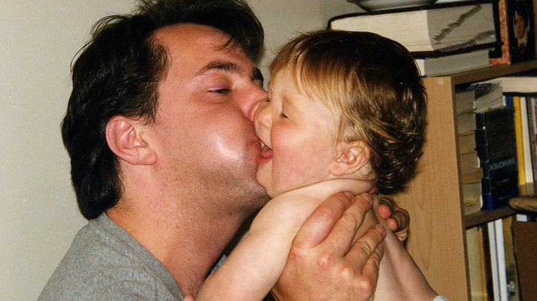 Photo of Andrew kissing baby Zachary on the cheek in Dear Zachary