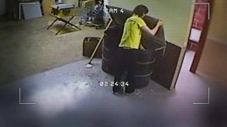 Video footage of a person reaching into a dumpster on Don't F**k with Cats