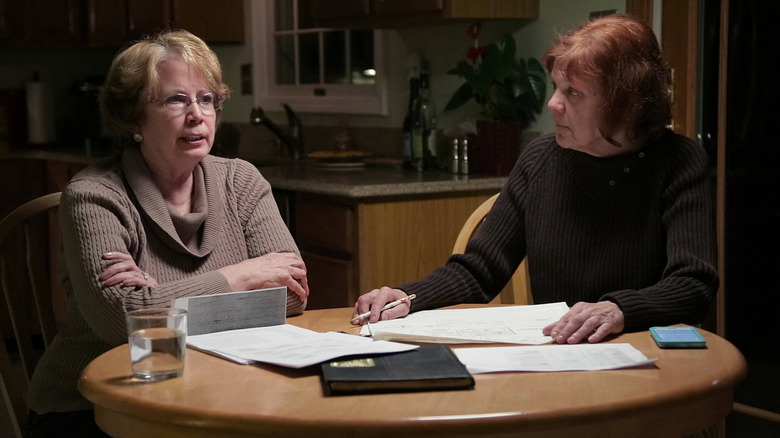 Abbie Fitzgerald Schaub and Gemma Hoskins talking at a table on The Keepers