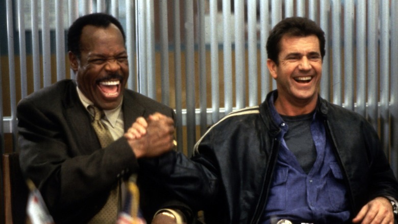 Glover and Gibson clasp hands