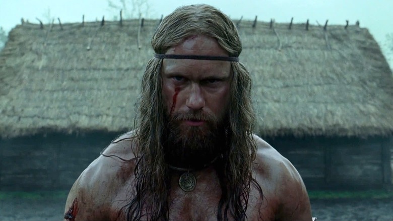 Amleth next to a thatched-roof home in The Northman (2022)
