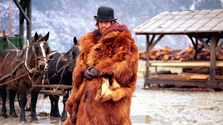 John McCabe, wearing a large furred coat, arriving in Presbyterian Church, Washington, in McCabe and Mrs Miller (1971)