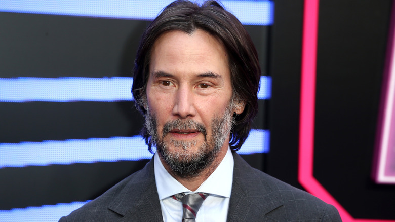 Keanu Reeves smiling at the premiere of From The World Of John Wick Ballerina