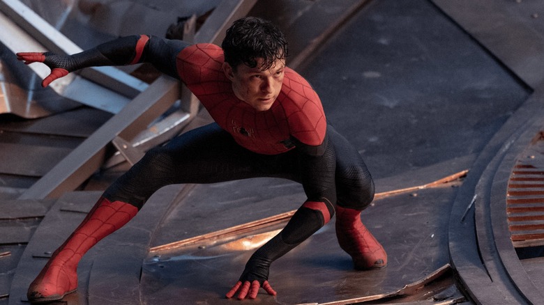 An unmasked Spider-Man crouched in "Spider-Man: No Way Home"