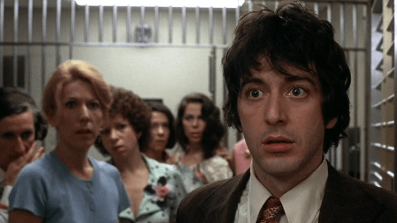Sonny looking worried in front of hostages in Dog Day Afternoon