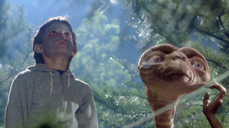 E.T. and Elliott looking up at the sky at night