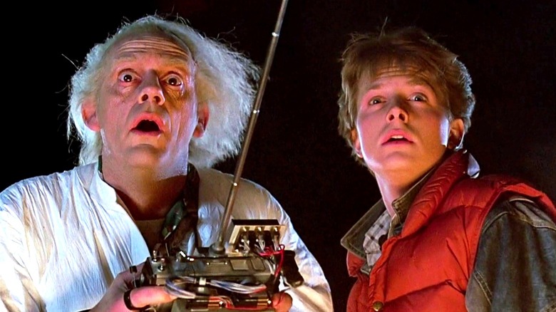 Doc Brown holding a remote with a long antenna next Marty McFly in Back to the Future