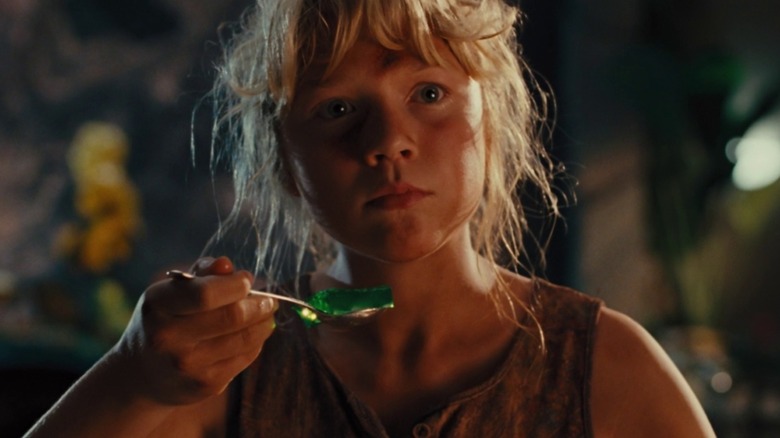 Lex holds a jiggling spoonful of green Jell-O in Jurassic Park