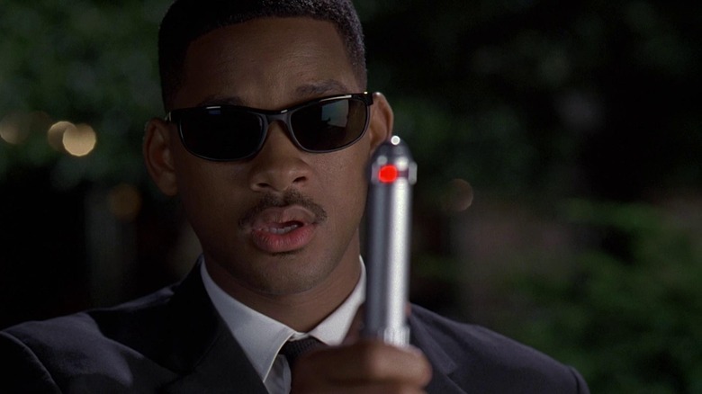 Agent J holds up a memory wipe device in Men in Black