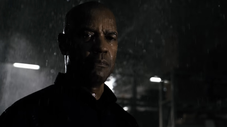 Robert McCall stands in the rain in "The Equalizer"