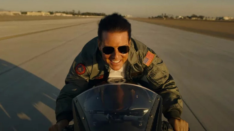 Pete "Maverick" Mitchell smiling on a motorbike in "Top Gun: Maverick"