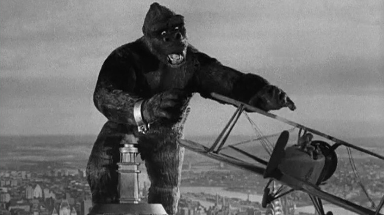 King Kong on top of the Empire State Building, reaching toward a plane, in "King Kong."