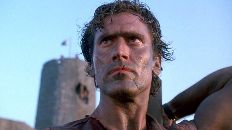 Ash Williams with a castle in the background in Army of Darkness