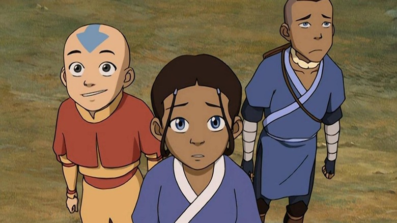 Aang, Katara, and Sokka standing together while looking up in "Avatar: The Last Airbender" (2005-2008)