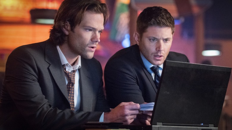 Sam and Dean watching something on a laptop in 