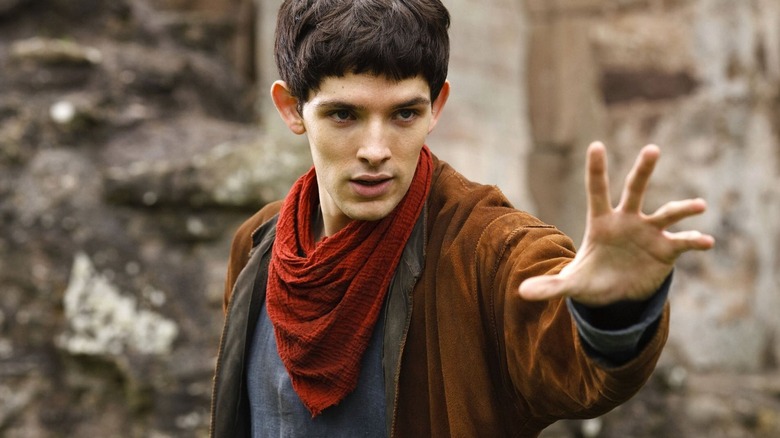 Merlin holding out his hand while performing magic in "Merlin" (2008-2012)