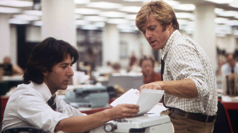 Bob Woodward and Carl Bernstein sit at a typewriter in "All the President's Men" (1976)