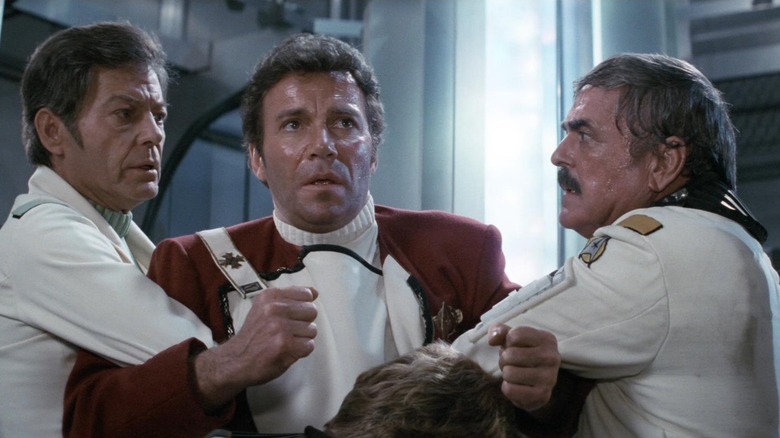 Bones and Scottie holding Captain Kirk back in "Star Trek II: The Wrath of Khan"