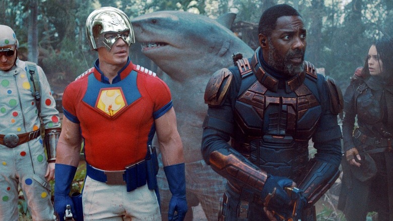 Peacemaker and Bloodsport leading Polka-Dot Man, King Shark, and Ratcatcher 2 through the jungle