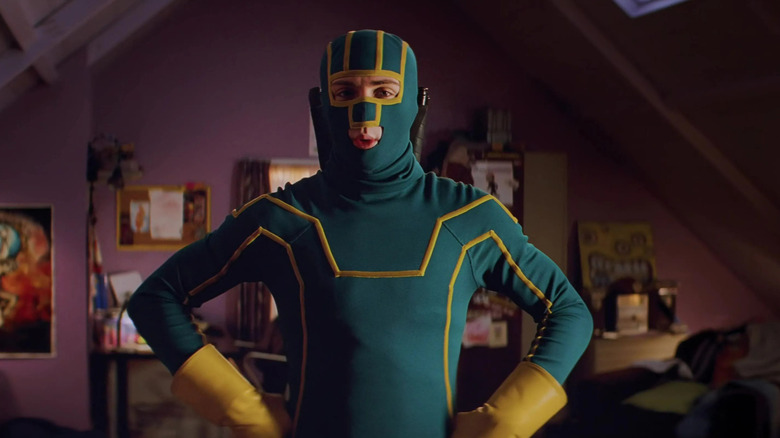 Dave posing and dressed up as his vigilante alter-ego Kick-Ass in his bedroom