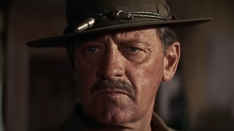 Pike scowling at a group of bankers in The Wild Bunch