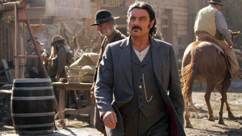 Al Swearengen walks down street of Deadwood
